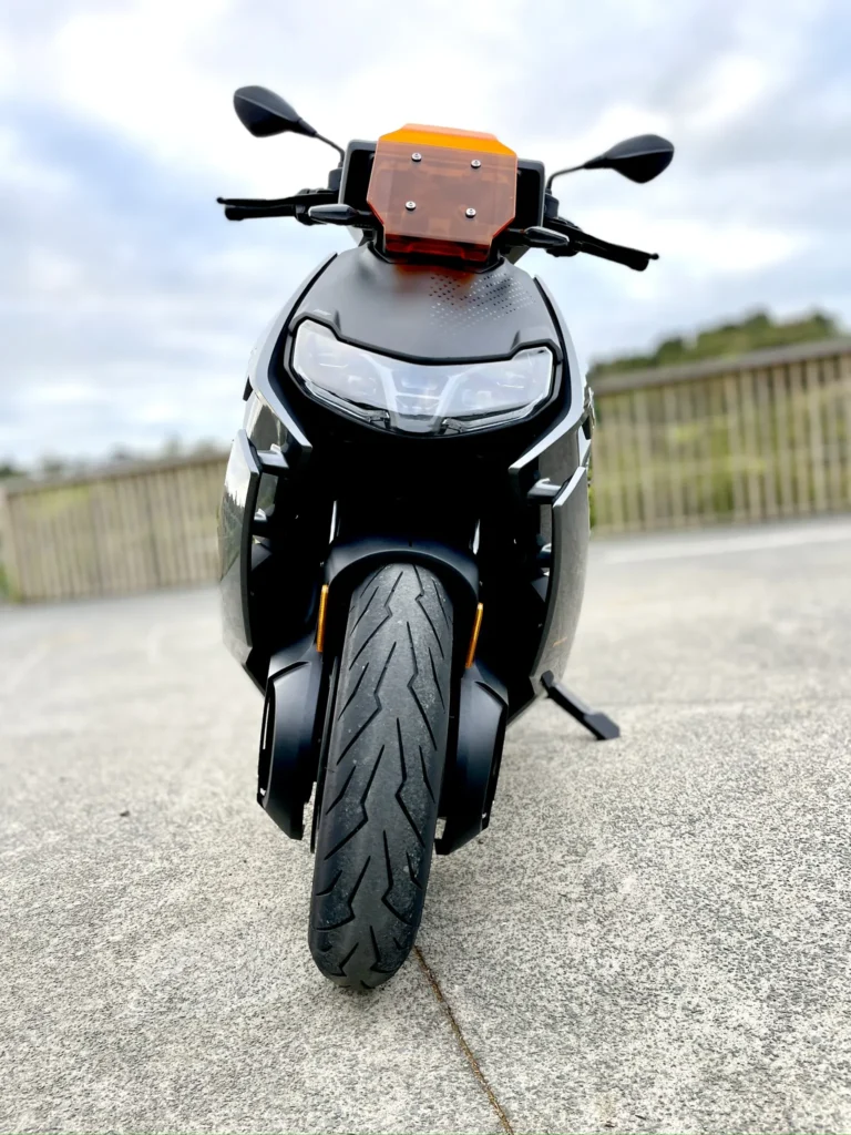 Front view of BMW CE 04 electric scooter parked outdoors