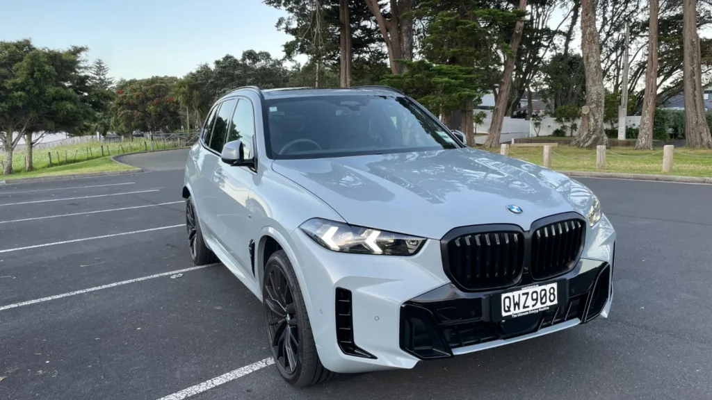 BMW X5 M Sport in grey parked outdoors, front three-quarter view
