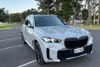 BMW X5 M Sport in grey parked outdoors, front three-quarter view