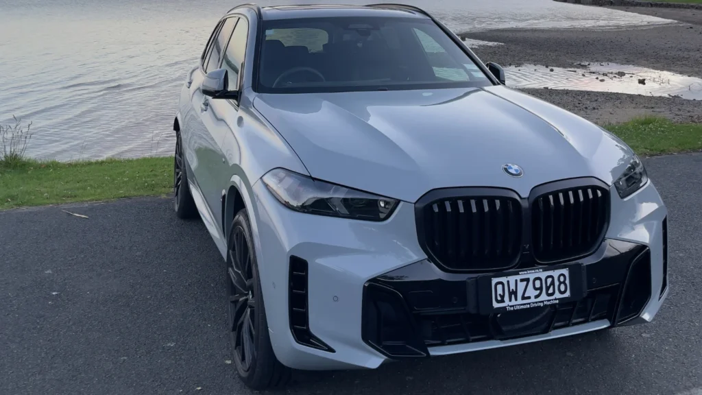 Front view of BMW X5 M Sport parked beside water