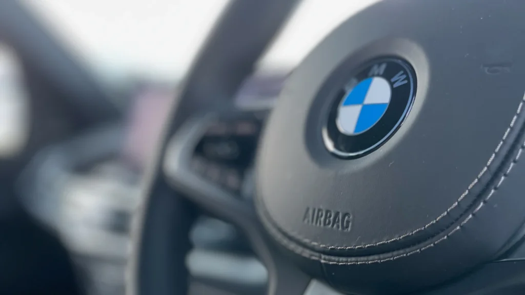 BMW X5 M Sport steering wheel with BMW logo inside the cabin