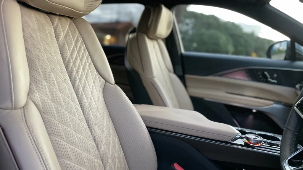 Front seats of the Cadillac Lyriq with quilted leather upholstery and wide center console