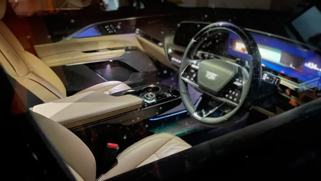 Cadillac Lyriq interior at night highlighting ambient lighting, center console, and digital cockpit