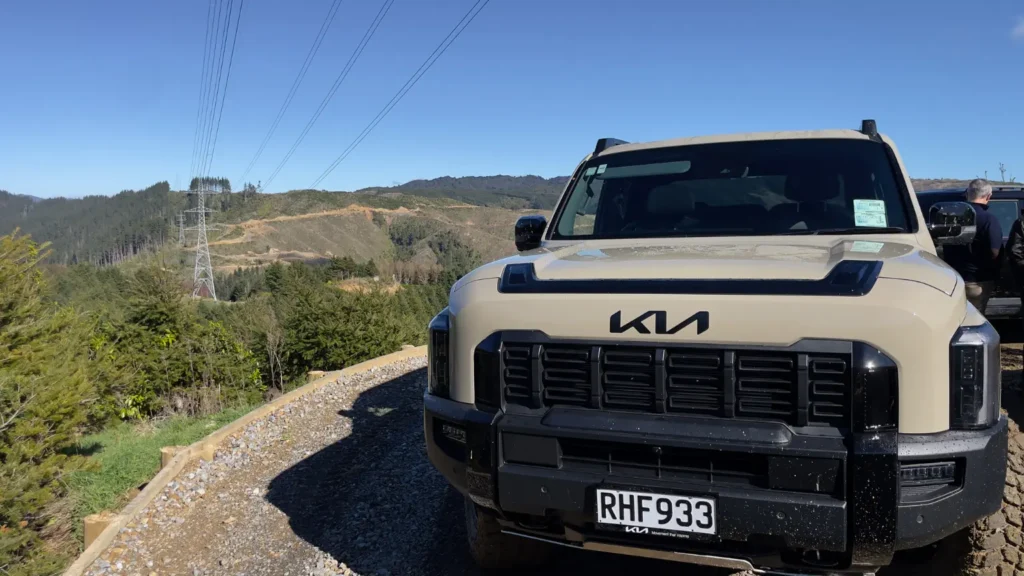 Kia Tasman front view parked on mountain gravel road