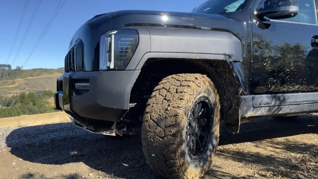 Kia Tasman side view highlighting front wheel and off-road stance