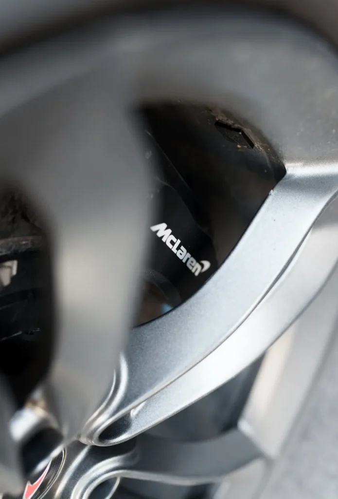 Close-up of McLaren logo on the wheel rim of a McLaren 650S