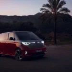 Volkswagen ID.Buzz electric Kombi parked outdoors at dusk with LED headlights on