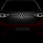 Front view of Volkswagen ID.Buzz with illuminated LED headlights and VW badge