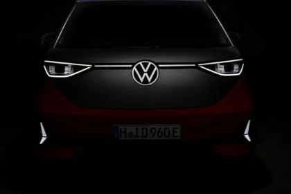 Front view of Volkswagen ID.Buzz with illuminated LED headlights and VW badge