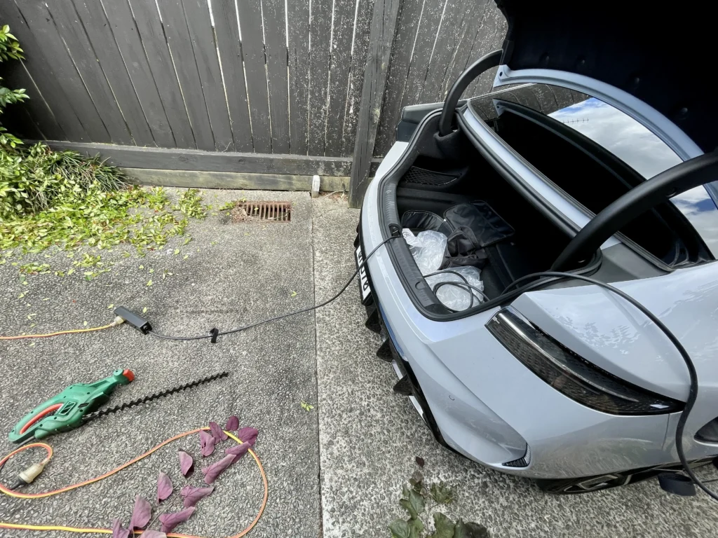 BYD Seal vehicle-to-load feature powering hedge trimmer from frunk in New Zealand