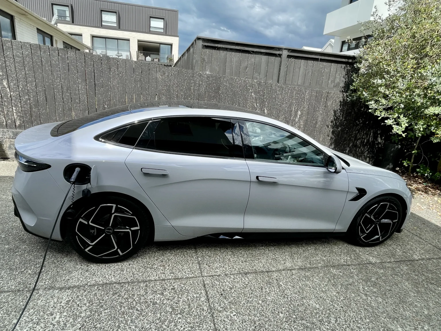 BYD Seal side profile charging at home driveway wall charger