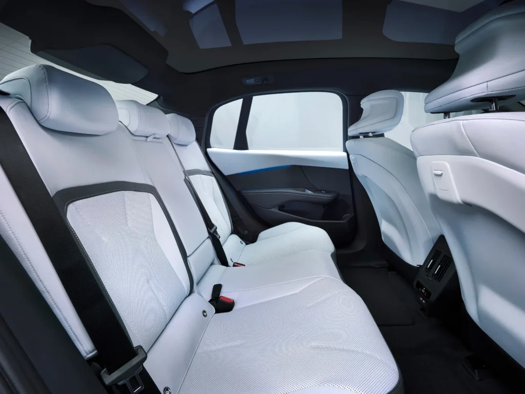 BMW i3 spacious rear passenger cabin with white leather seats, panoramic roof and blue accent lighting