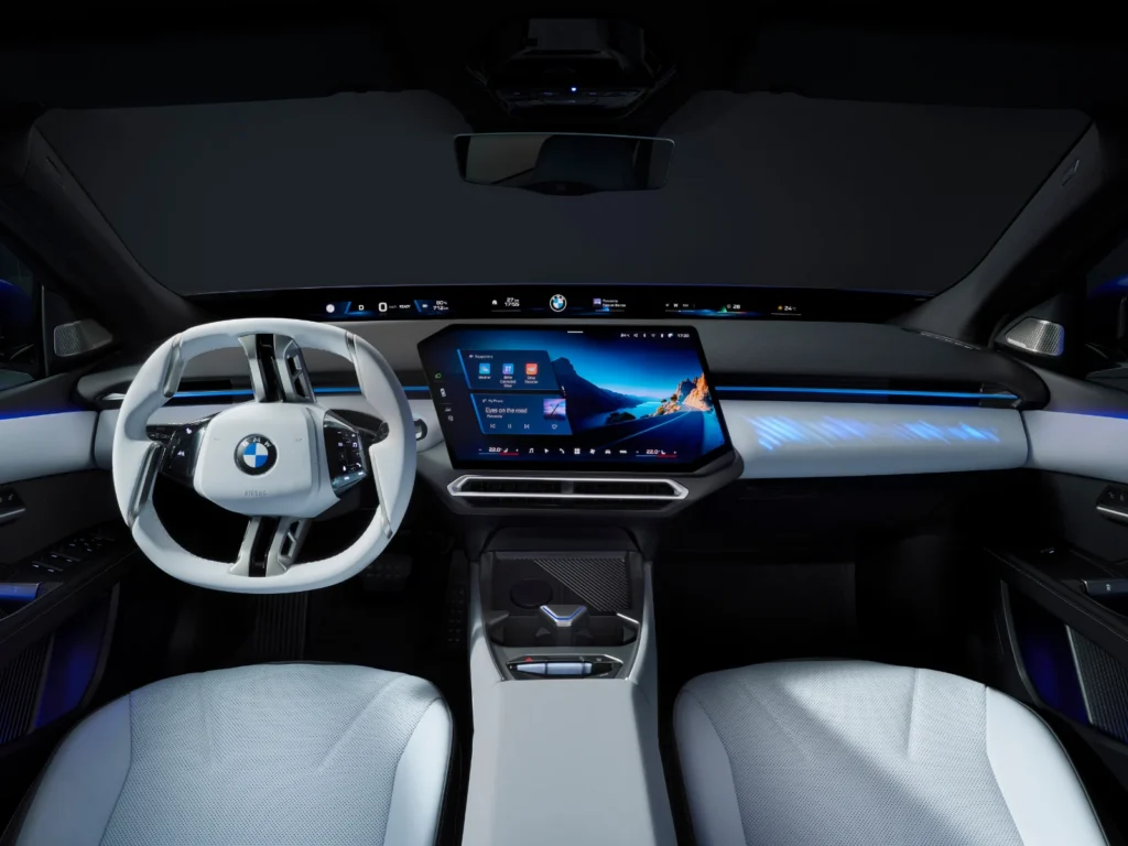 BMW i3 full interior dashboard view featuring Panoramic iDrive infotainment screen and white leather steering wheel