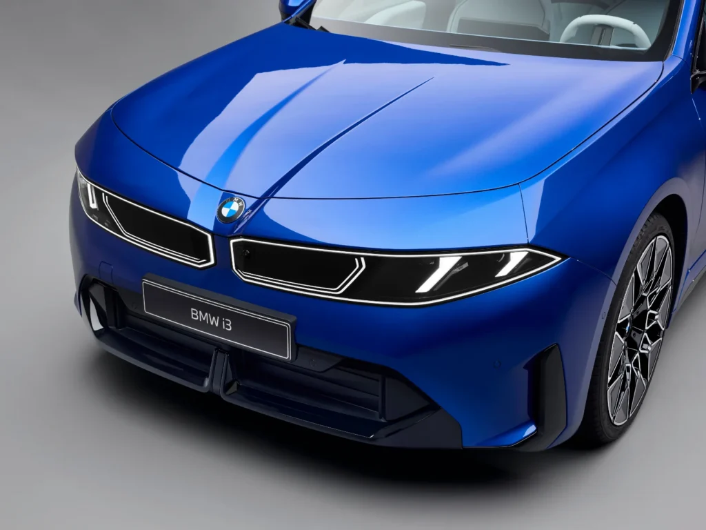 BMW i3 electric sedan front fascia in blue with twin LED headlights and iconic kidney grille design