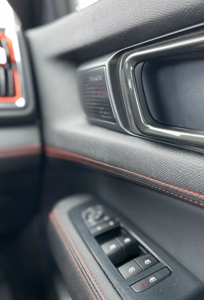 BYD Shark 6 interior door panel with controls and red stitching
