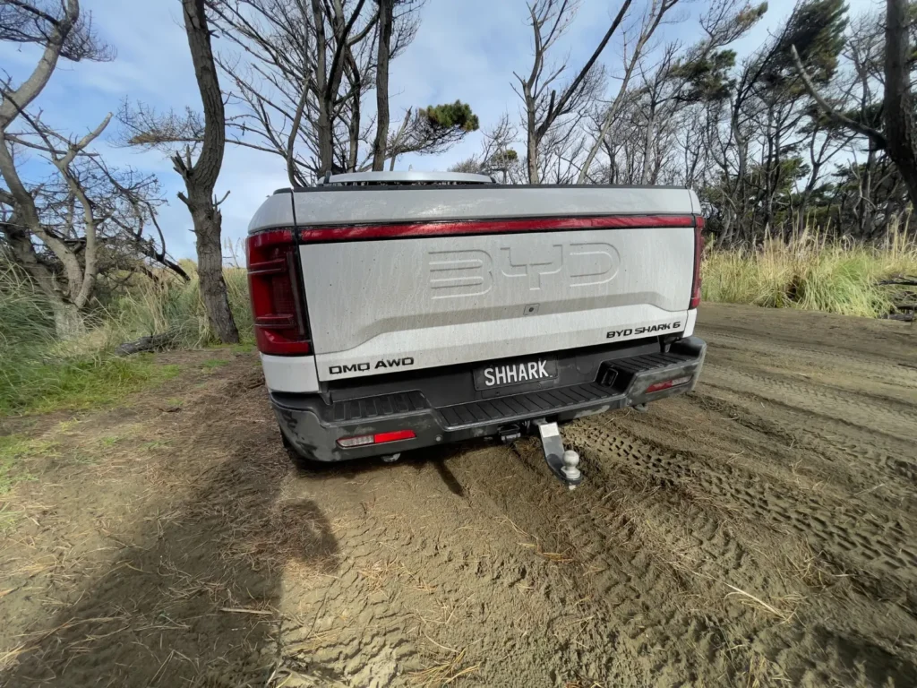 BYD Shark 6 rear angle showing tailgate and tow setup outdoors