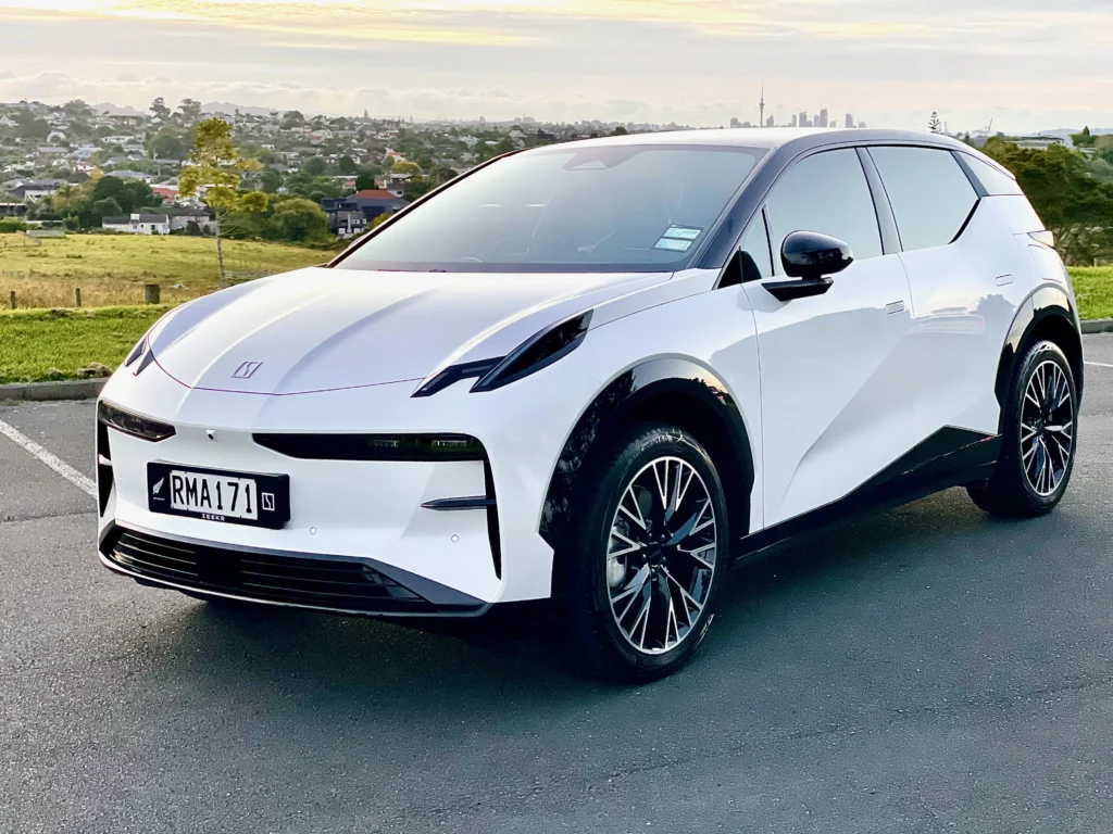 Zeekr X front three-quarter view with Auckland skyline in background